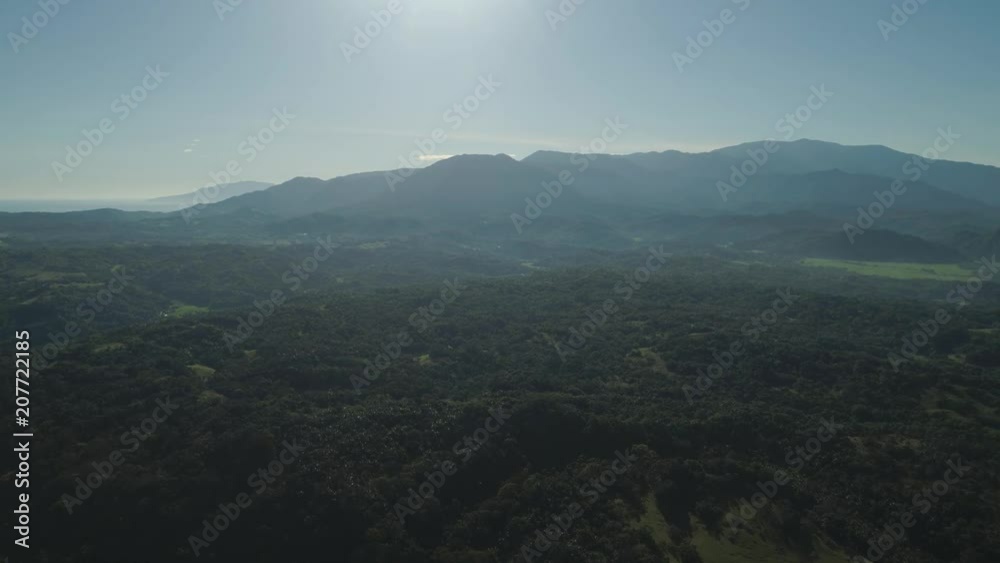 Aerial view of mountains covered green trees, rice terrace, agricultural farm land. Tropical landscape with farmlands on island Luzon, Pagudpud, Philippines. Aerial view of mountains covered green trees, rice terrace, agricultural farm land. Tropical landscape with farmlands on island Luzon, Pagudpud, Philippines.