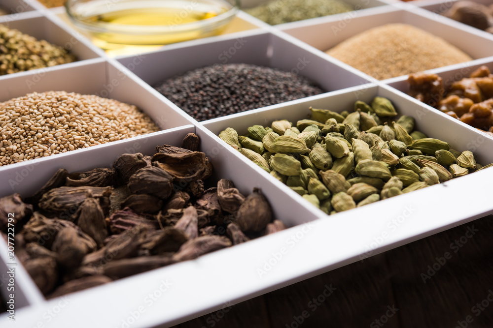 Obraz premium Indian Spices in white wooden box with cells, selective focus.