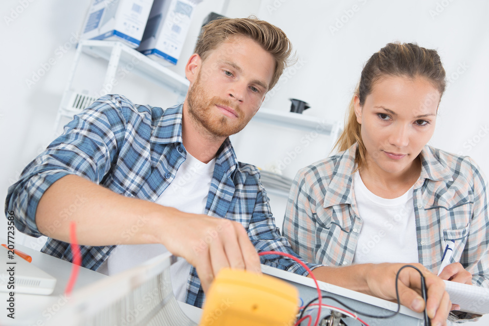 Fototapeta premium two workers working in electronic maintenance shop