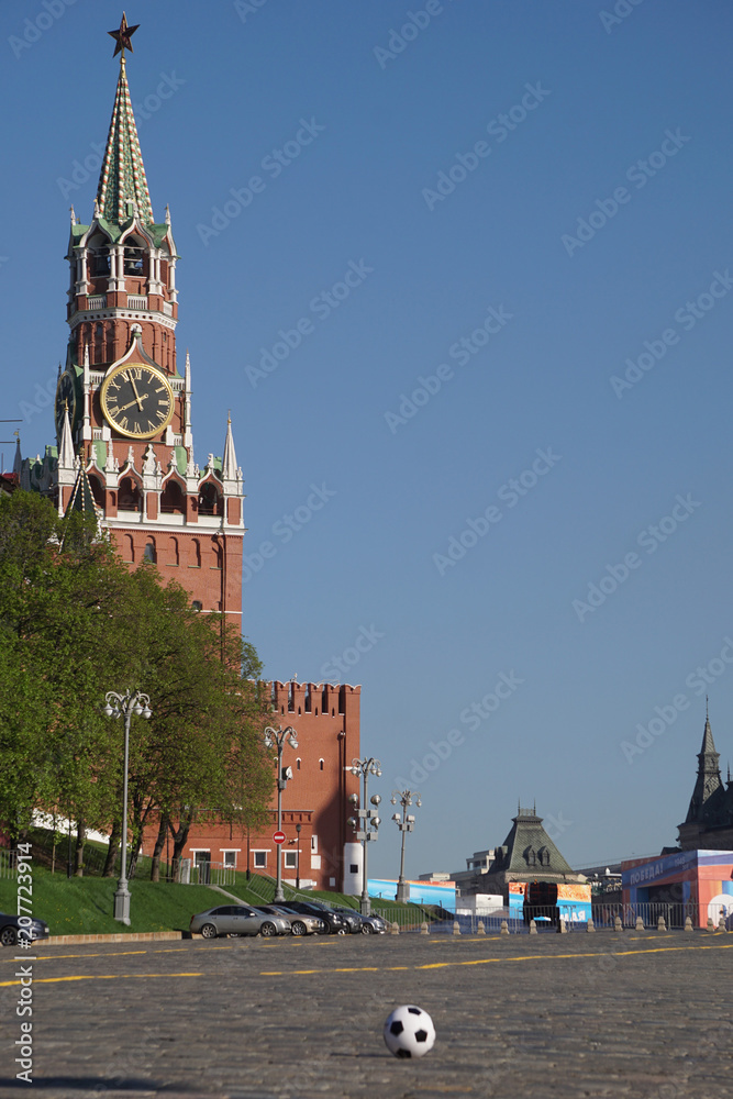 Fototapeta premium Moscow / Russia – 05.08.2018: image of a soccer ball on the Red Square in Moscow in front of the Spasskaya Tower of the Moscow Kremlin