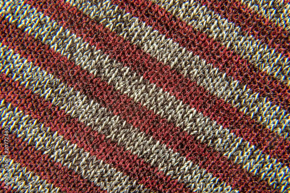 background of a fabric of red-gray striped weaving close-up background of a fabric of red-gray striped weaving close-up