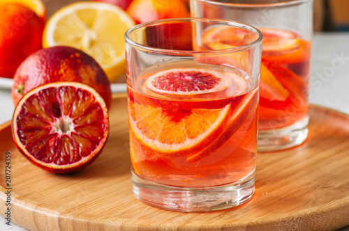Citrus infused water with slices of fruits. Seasonal beverages concept