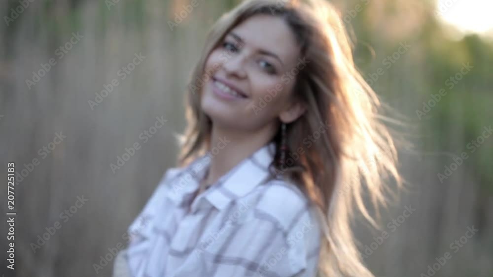 Cute charming girl in summer in the field. Young woman is happy and feels free, outdoors Cute charming girl in summer in the field. Young woman is happy and feels free, outdoors