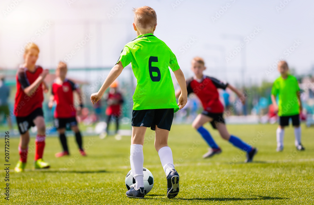 Obraz premium Boys Kicking Soccer Match on Grass. Youth Football Game. Children Sport Competition. Kids Playing Outdoor