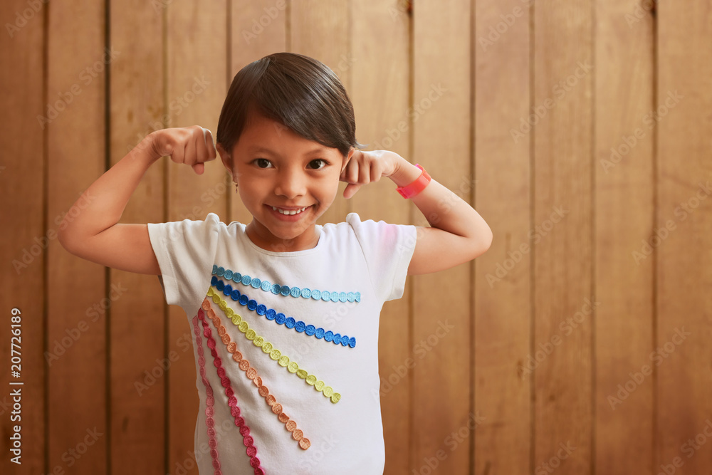 Asian little girl showing muscles Asian little girl showing muscles