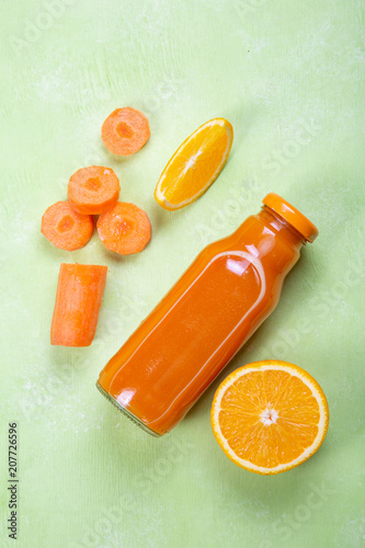 Creative layout of fresh orange and carrot smoothie