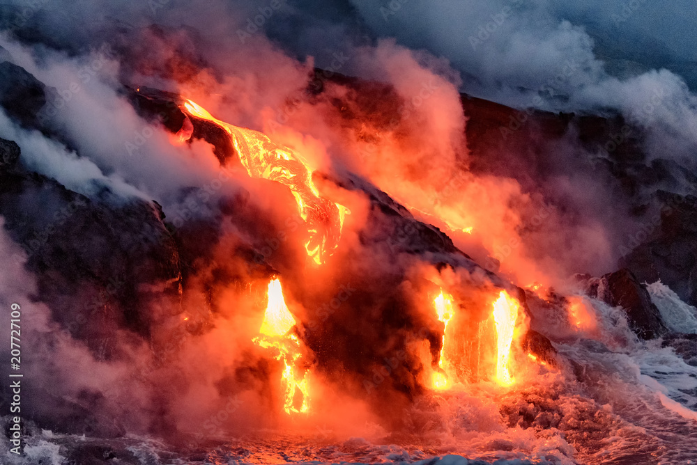 Molten lava flowing into the Pacific Ocean on Big Island of Hawaii at sunrise Molten lava flowing into the Pacific Ocean on Big Island of Hawaii at sunrise