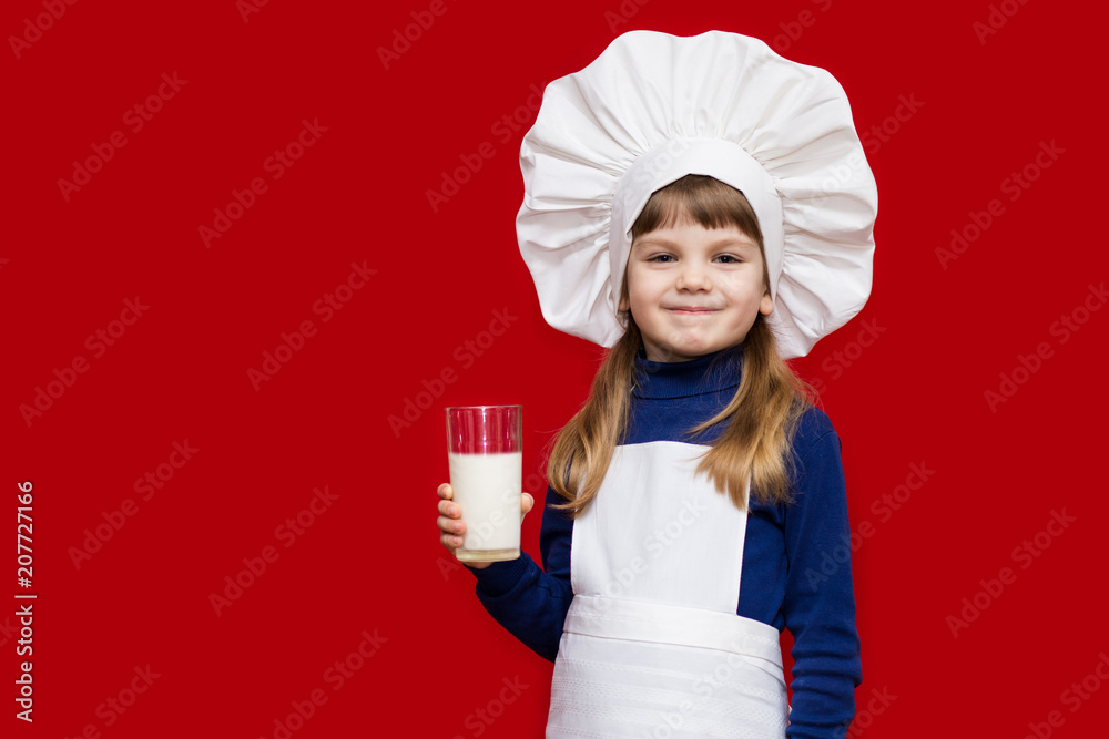 Portrait of beautiful little girl in form of cook isolated on red drink milk. Kid chef. healthy habits Portrait of beautiful little girl in form of cook isolated on red drink milk. Kid chef. healthy habits