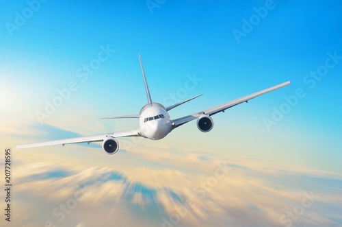 Airplane in the sky above the clouds flight journey sun height speed motion blur.