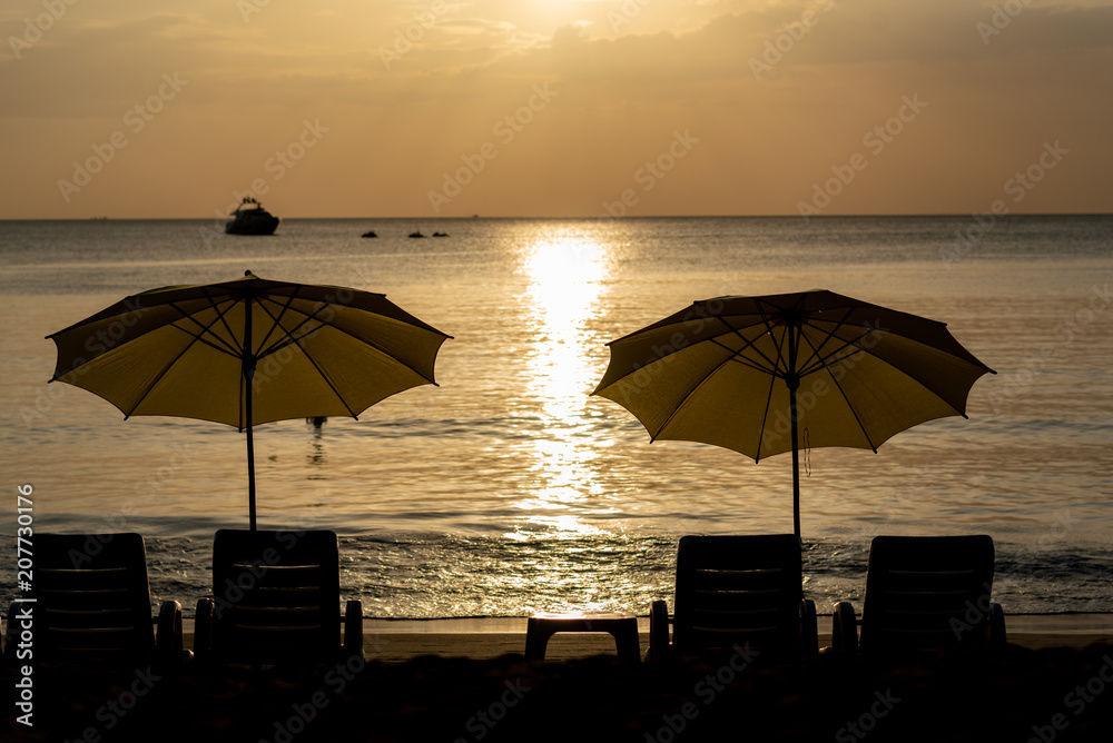 Luxury yellow beach umbrella and beach chair setup on Kamala beach, phuket, thailand