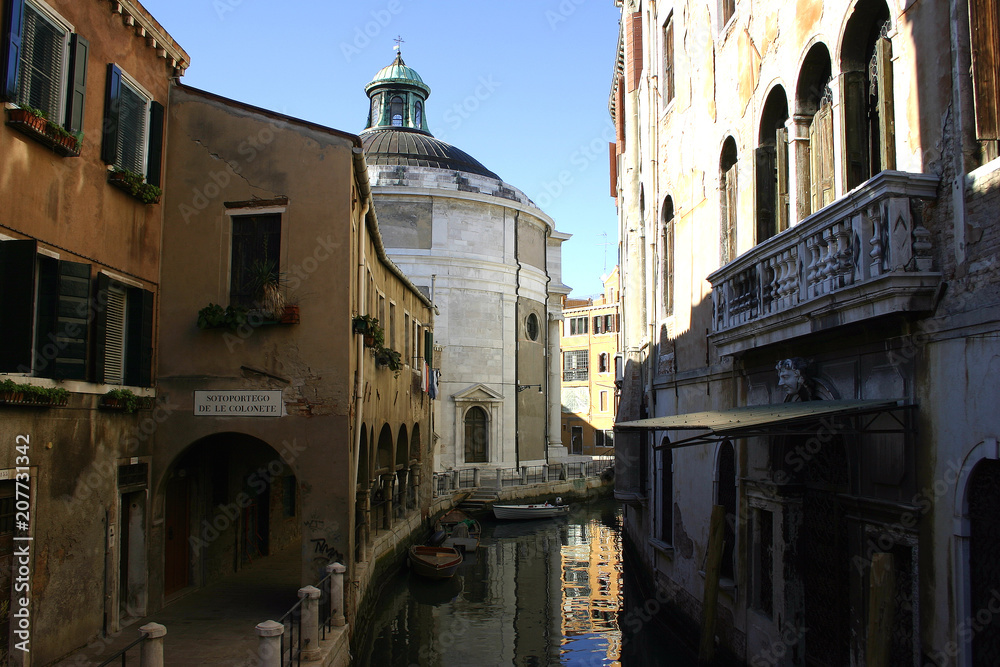 little canal with historic houses in venice