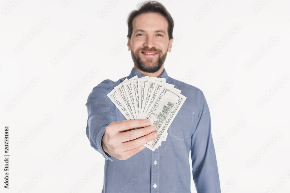 smiling bearded man showing dollar banknotes in hand isolated on white smiling bearded man showing dollar banknotes in hand isolated on white