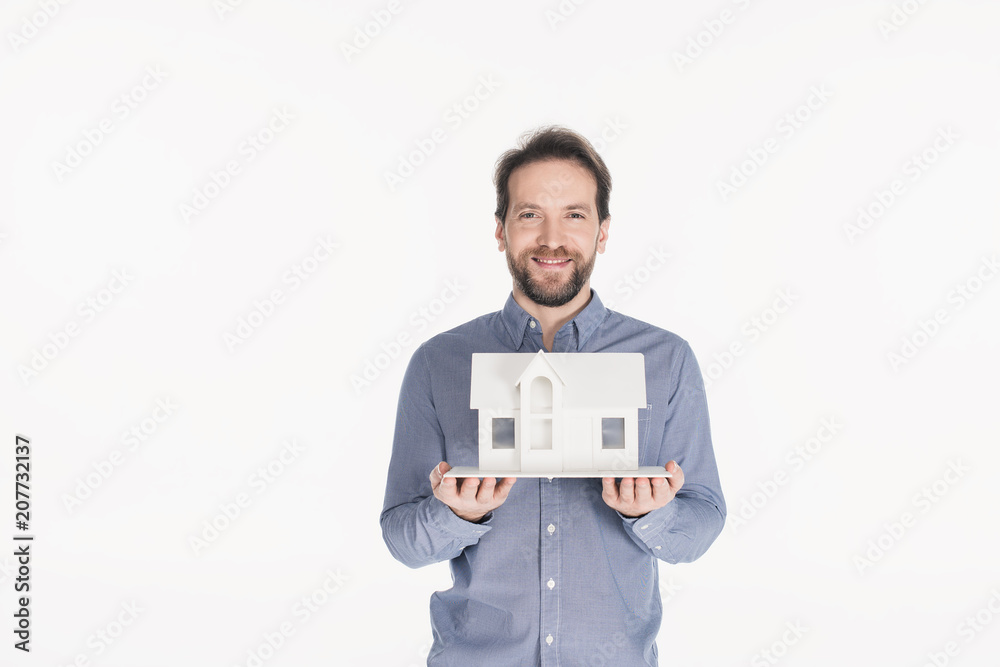 portrait of cheerful bearded man holding house model in hands isolated on white portrait of cheerful bearded man holding house model in hands isolated on white