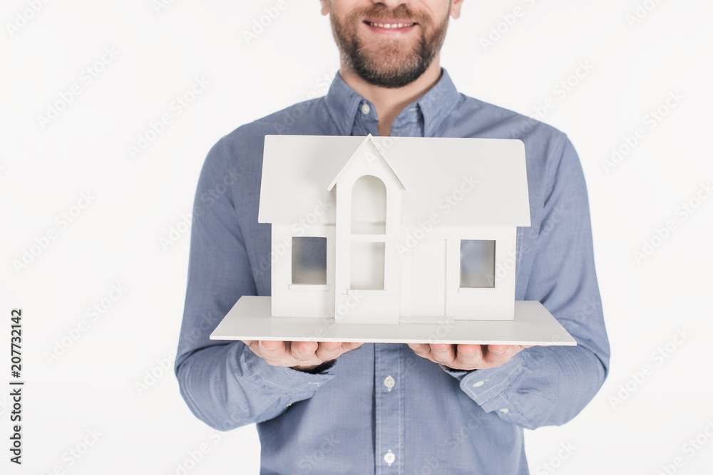 cropped shot of bearded man holding house model in hands isolated on white cropped shot of bearded man holding house model in hands isolated on white