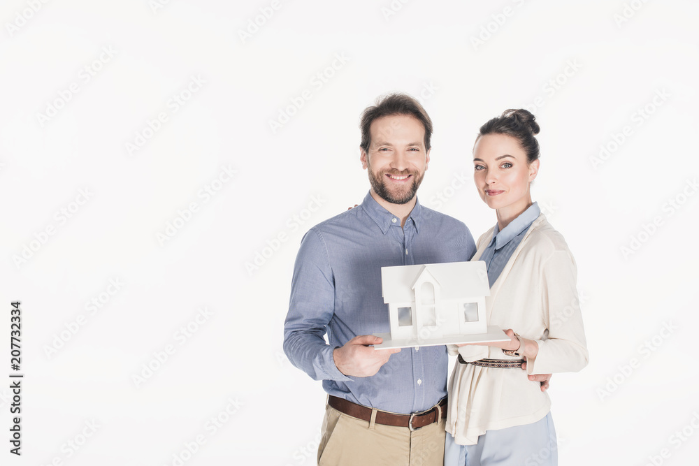 portrait of married couple with house model isolated on white portrait of married couple with house model isolated on white