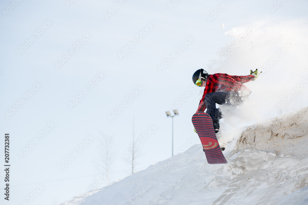 Image of man with snowboard jumping from mountain slope