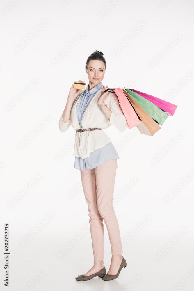 stylish woman with shopping bags and credit card in hands isolated on white stylish woman with shopping bags and credit card in hands isolated on white