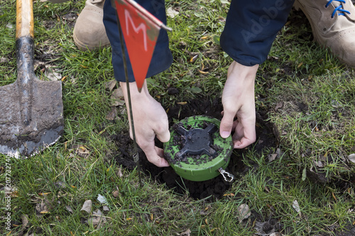 miner digs a mine. Demining of the territory. the guys digs a mine on a minefield. service in army. hazardous work. digging the ground with a sapper shovel