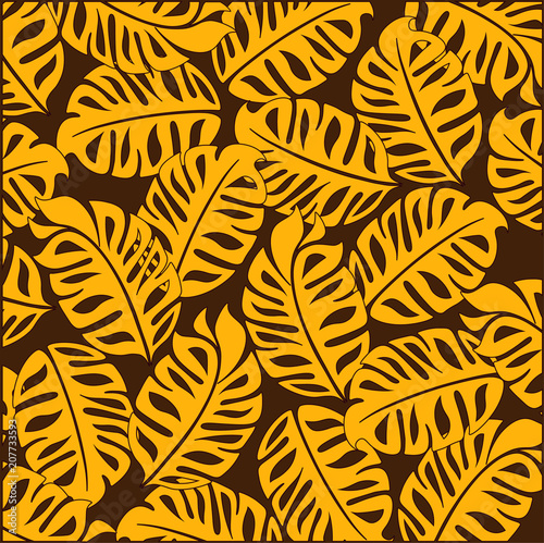 Bright tropical design. On a dark brown background bright yellow tropical leaves.