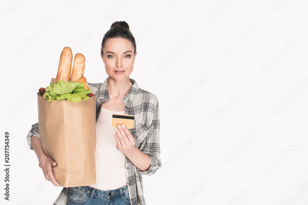 portrait of woman with paper package full of food and credit card in hands isolated on white portrait of woman with paper package full of food and credit card in hands isolated on white