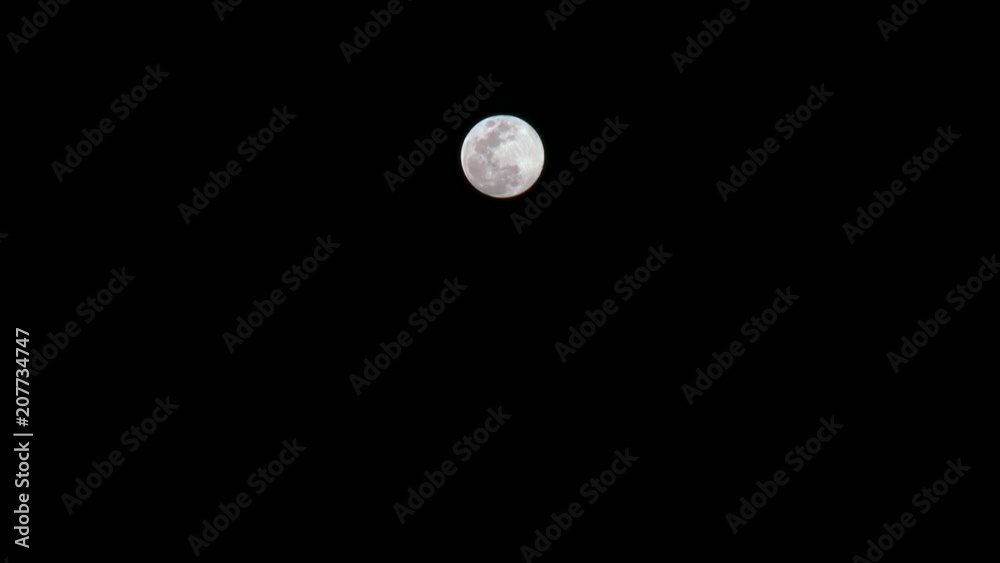 Full moon with silhouette of birds flying towards the moon. Shaped full moon in a black night. Lunar surface with craters and valleys. Full moon with silhouette of birds flying towards the moon. Shaped full moon in a black night. Lunar surface with craters and valleys.