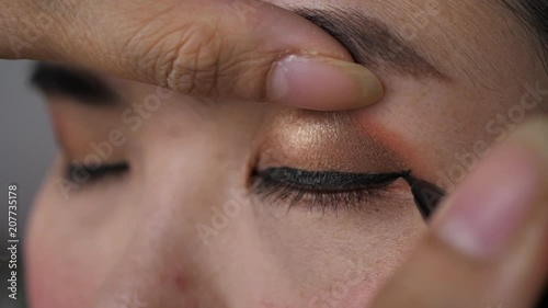 slow motion, beautician using eyeliner pen makeup beauty of beautiful eye