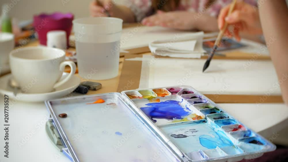 Young woman artist painting at home studio creative tools close-up Young woman artist painting at home studio creative tools close-up