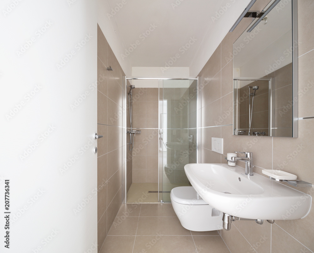 Modern bathroom with large tiles in newly built apartment Modern bathroom with large tiles in newly built apartment