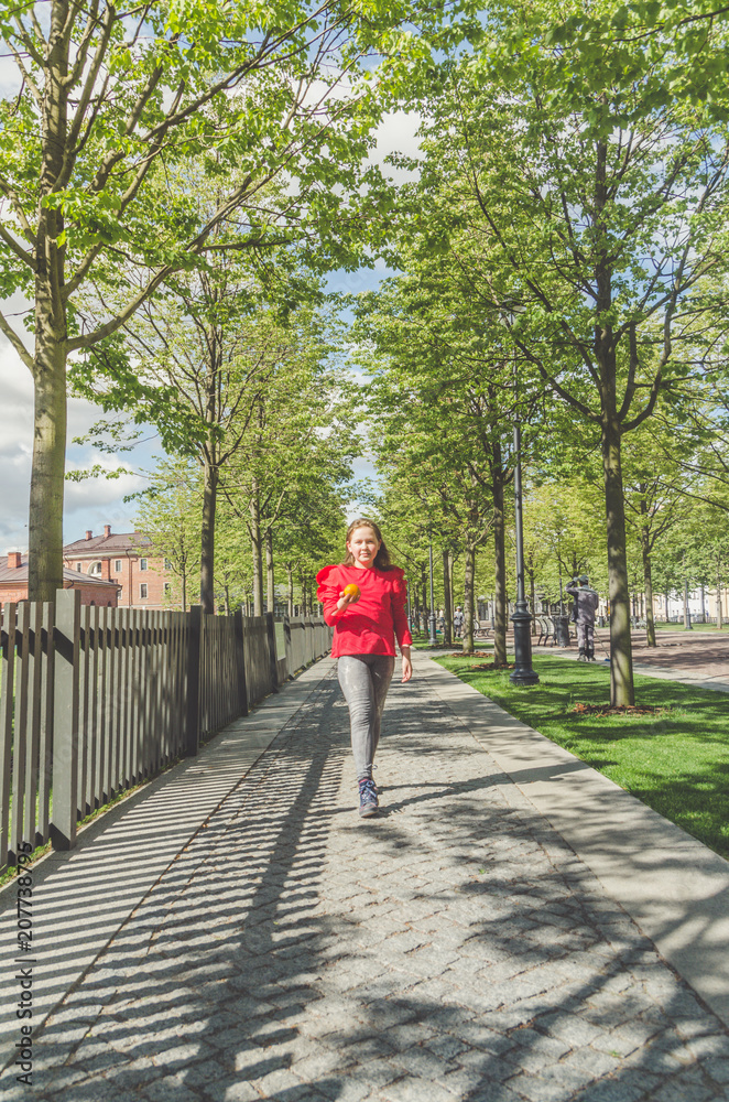 girl in the Park with a delicious fragrant orange