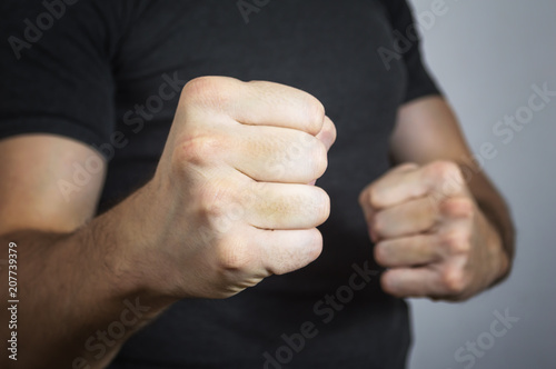 Caucasian man with a threatening gesture