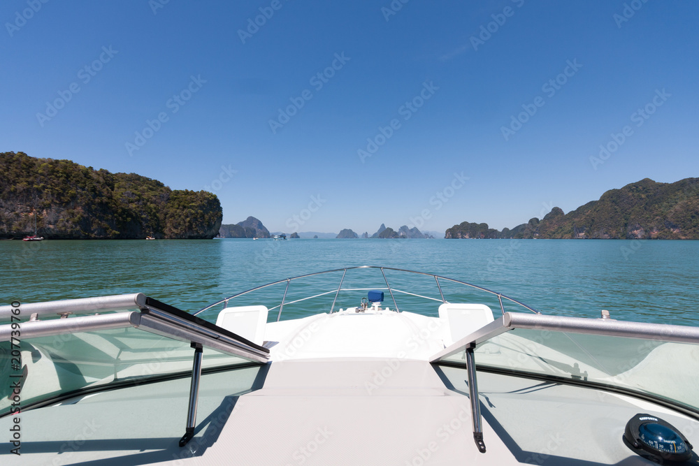 Fototapeta premium Cruising on a motorboat through the limestone islands of Phang Nga Bay, Phuket, Thailand