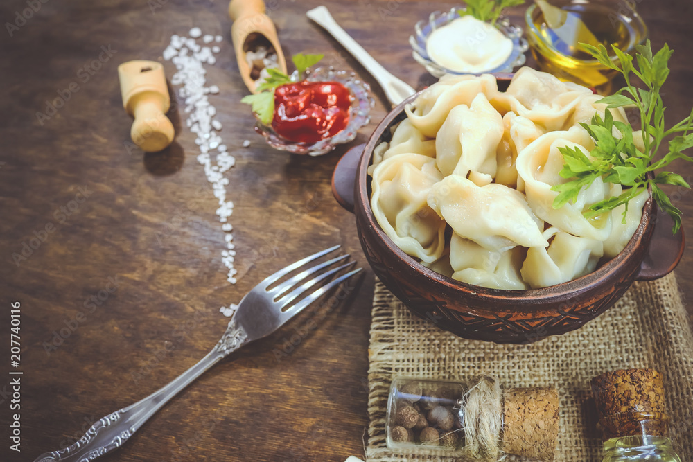 dumplings in earthenware. food ingredients. wooden background.