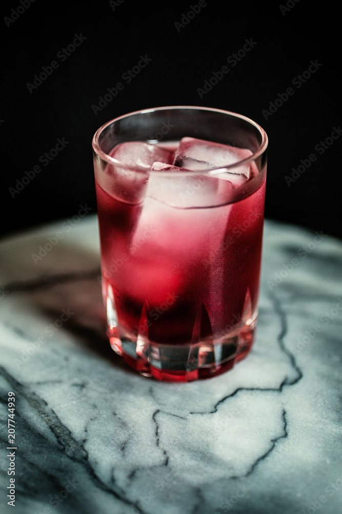 tumbler with icy red drink on marble table tumbler with icy red drink on marble table
