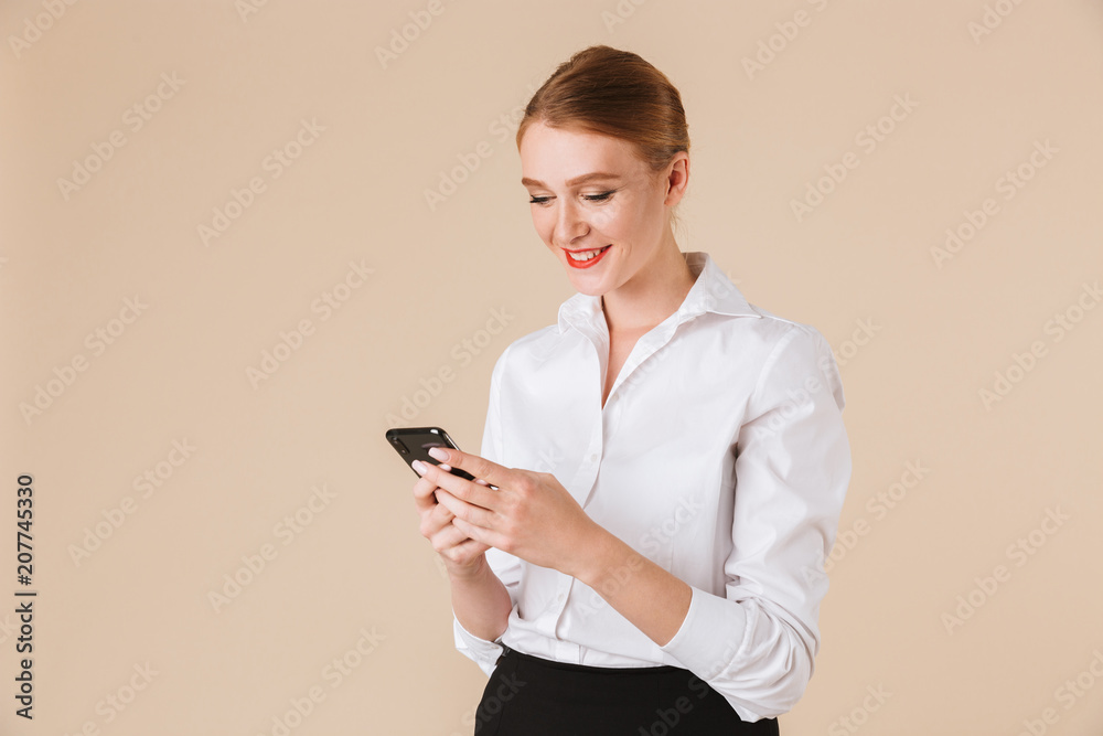 Cheerful young business woman using mobile phone. Cheerful young business woman using mobile phone.