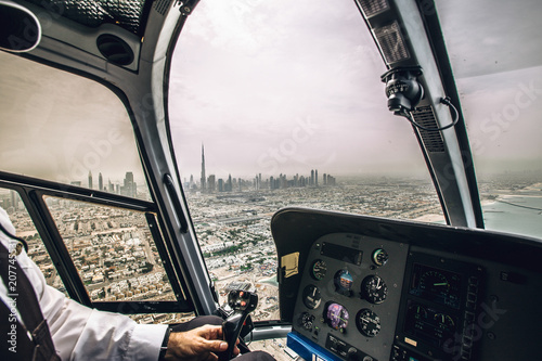 Dubai, UAE inside of helicopter with view on downtown city center , sea.