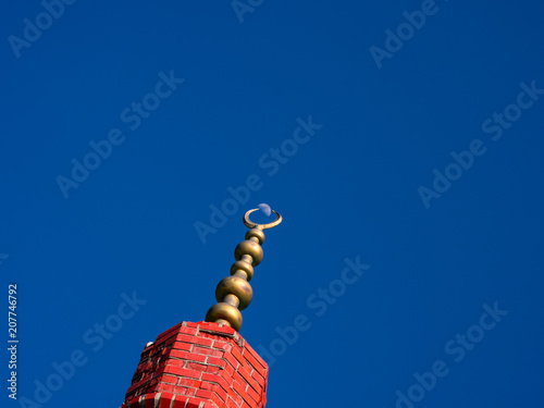 Photography Turkish half-moon over the brick tower and real moon with blue sky background