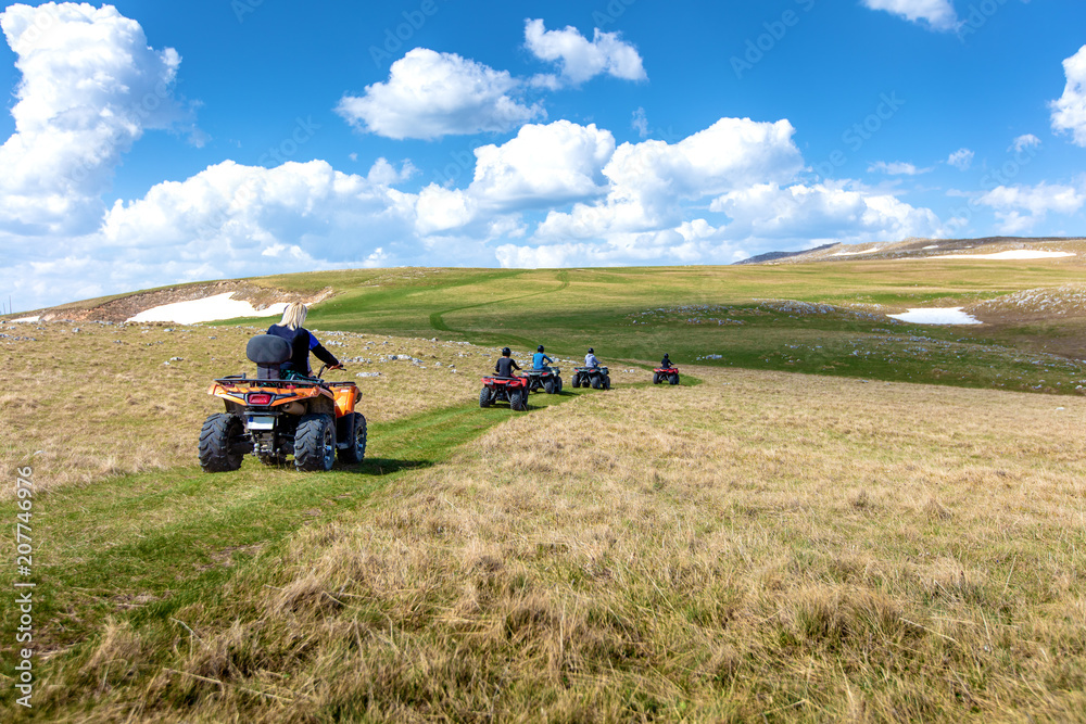 Friends driving off-road with quad bike or ATV and UTV vehicles Friends driving off-road with quad bike or ATV and UTV vehicles