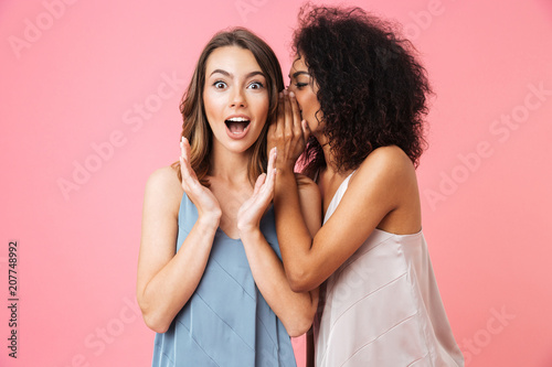 Two excited young girls dressed in summer clothes