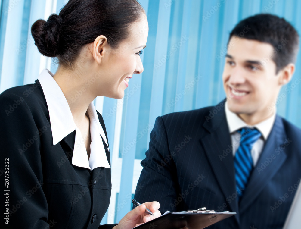 Three businesspeople working with document at office. Focus on woman. Three businesspeople working with document at office. Focus on woman.