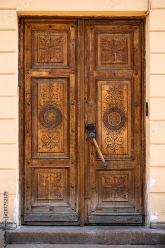 Brown vintage wooden door with elegant carving