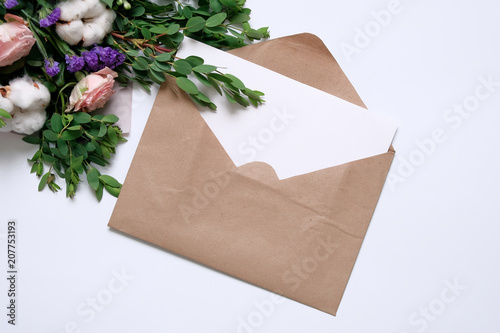 Mockup with postcard, flowers bouquet, kraft envelope. photo