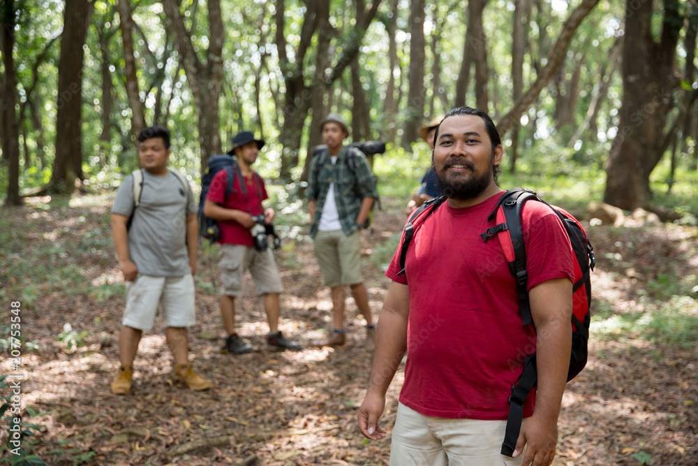 smiling to camera while hiking in the forest smiling to camera while hiking in the forest