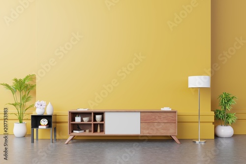 Cabinet TV in modern living room with lamp table flower and plant on yellow wall background 3d rendering