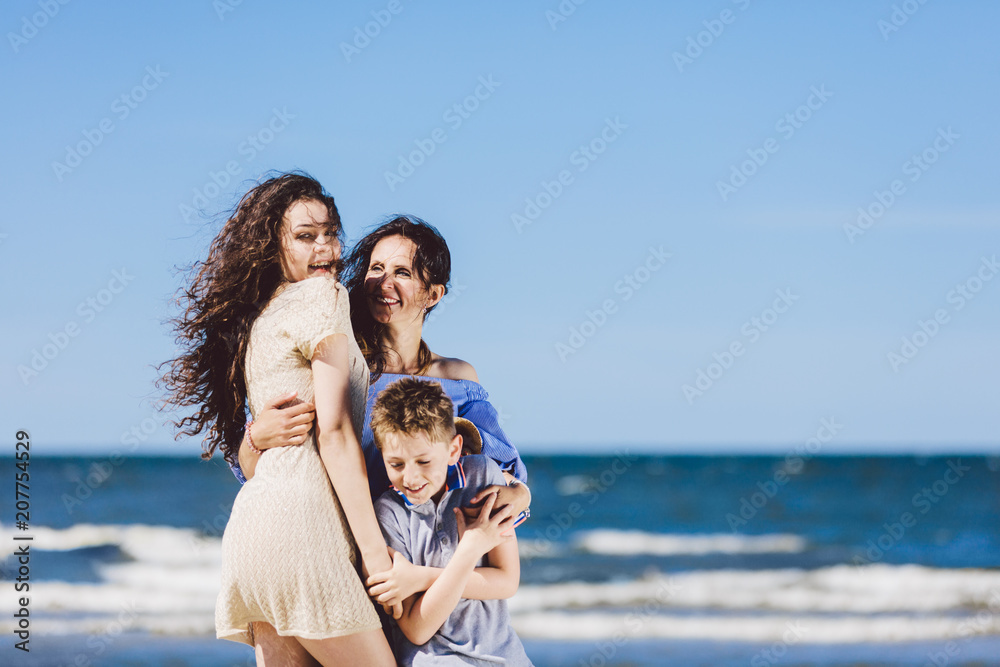 Mother, daughter and son hugging on the beach. Mother, daughter and son hugging on the beach.