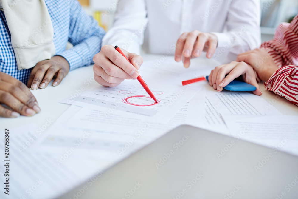 Close-up of business people planning work togther at the table. They working in team