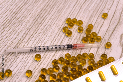 ampoules and syringe on white background. medical ampoules with syringe isolated. selective focus. Medicine in vials and syringe ready for injection photo