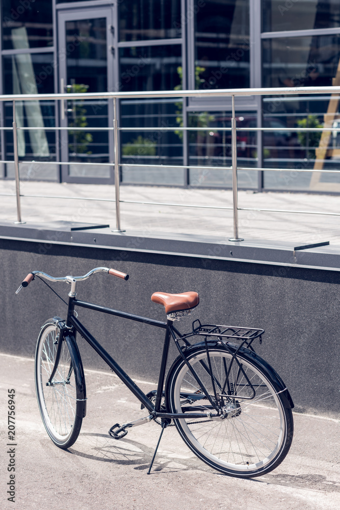 close up view of retro bicycle parked on street close up view of retro bicycle parked on street