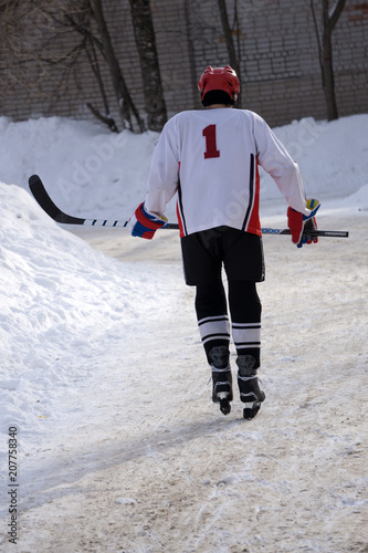 Photography Ice hockey player in blue wear and green helmet .
