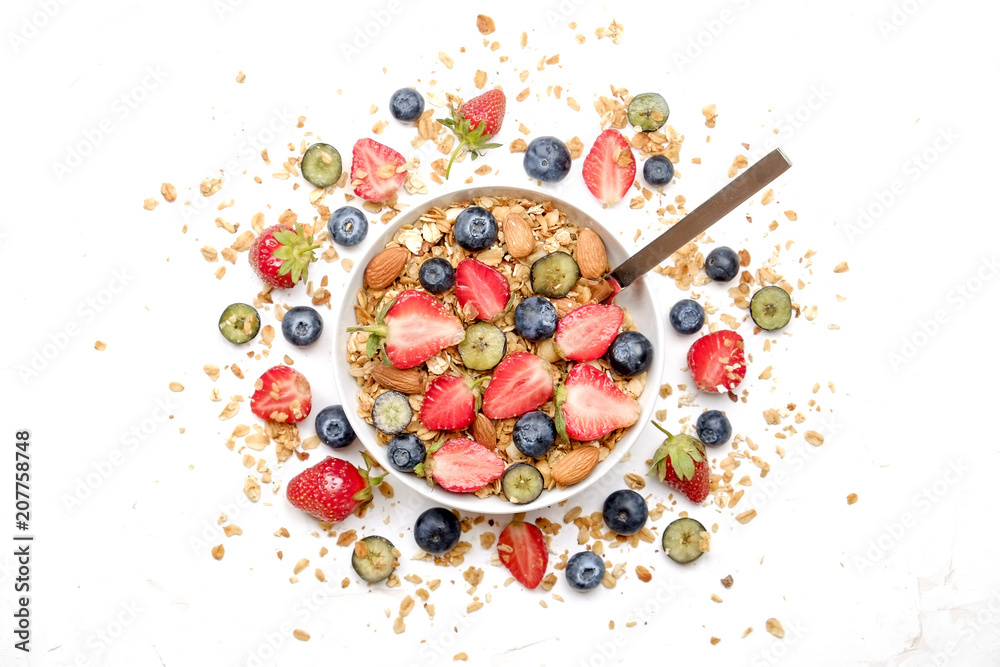 Serving option of granola bowl, mix of nuts, cereals, fruits & berries, greek yogurt, spoon. Healthy vegetarian breakfast, organic strawberry, blueberry, mint, almond. Close up, top view, background. Serving option of granola bowl, mix of nuts, cereals, fruits & berries, greek yogurt, spoon. Healthy vegetarian breakfast, organic strawberry, blueberry, mint, almond. Close up, top view, background.