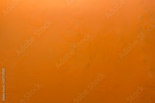 Cement orange wall background weathered wrinkled yellow .